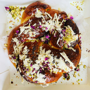 Image of the Yasmin Bakery & Catering round shape mouthwatering and delicious Nuttela chocolate Babka cake with sprinkles of Chalva and crushed pistachio..