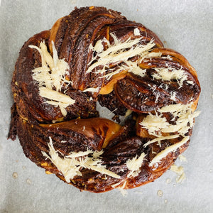 Image of the Yasmin Bakery & Catering round shape mouthwatering and delicious Nuttela chocolate Babka cake with sprinkles of Chalva.