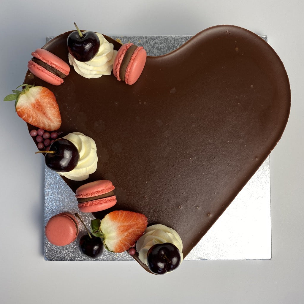 Top view image of Yasmin Bakery & Catering heart shaped Image of Yasmin Bakery & Catering round shape Rich, indulgent chocolate mousse cake with 3 layers boasts with a super creamy chocolate filling.